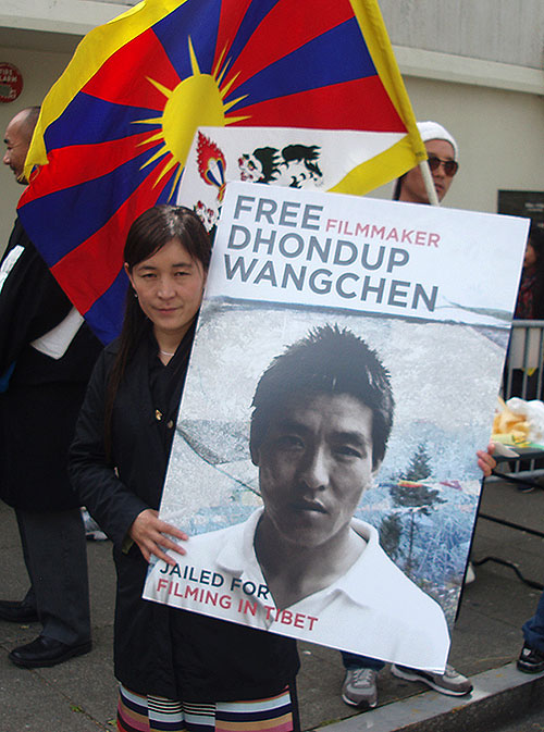 Lhamo Tso holding a poster of her husband Dhondup Wangchen